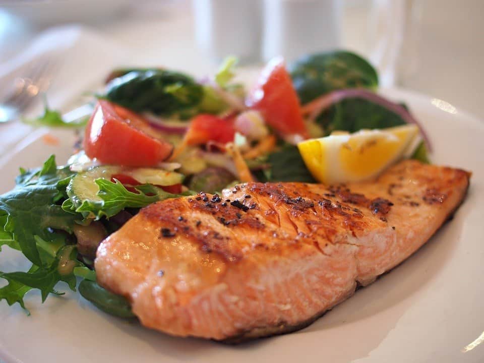 grilled salmon with lettuce, tomatoes, and cucumber